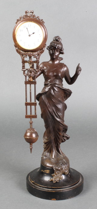 A Mystery clock with enamelled dial and Roman numerals supported by a spelter figure of a standing lady 