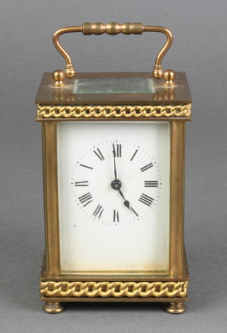 A 19th Century French 8 day carriage timepiece with enamelled dial and Roman numerals contained in a gilt metal case 
