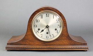 A chiming mantel clock with silvered dial contained in an oak Admiral's hat shaped case 