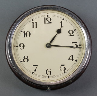 An Art Deco wall clock with painted dial and Arabic numerals contained in a brown Bakelite and chrome case 6 1/2" 