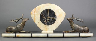 An Art Deco timepiece contained in a 2 colour marble case supported by 2 figures of seated stags 