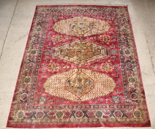 A Persian style pink and gold ground carpet with 3 medallions to the centre and having animal decoration 142" x 108" 