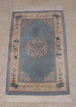A blue ground and floral patterned Chinese rug 63" x 36 1/2" 