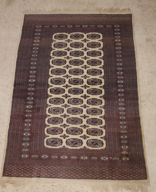 A white ground Bokhara rug with 36 octagons to the centre 77" x 50" 