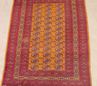 A tanned ground Bokhara carpet  with 39 octagons to the centre 79" x 52"  (some wear) 