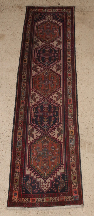 A Persian white and blue ground Sarab runner with 5 diamond shaped medallions to the centre within a multi row border 112" x 29" 