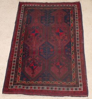 A Persian Kurdish red and blue ground rug with stylised diamonds to the centre 79" x 53" 