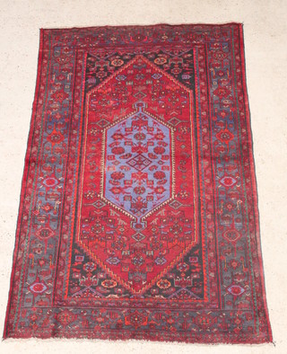 A Persian blue and red ground Toyserkan rug with diamond shaped medallion to the centre 78" x 51" 