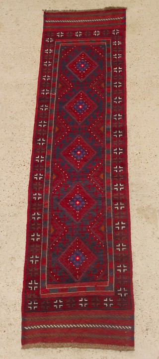 A red and blue ground Meshwani runner with 5 diamonds to the centre 95" x 23" 