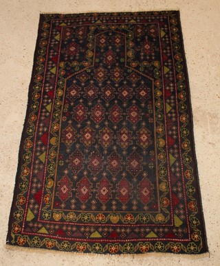 A Persian black and brown ground prayer rug 86" x 35" 
