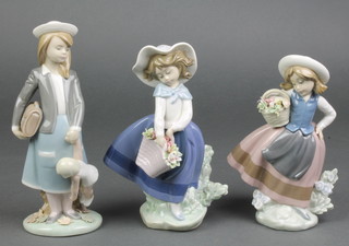 A Lladro figure of a young girl carrying a doll 7", a ditto of a young girl holding a basket of flowers 6 1/2" and a similar 7" 