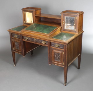 A late 19th Century mahogany Dickens style desk the super structure fitted 2 cupboards enclosed by bevelled mirror panelled doors with slope above 1 long and 2 short drawers and double cupboards, having blind fret work decoration, raised on square tapering supports 42"h x 48"w x 24"d 
