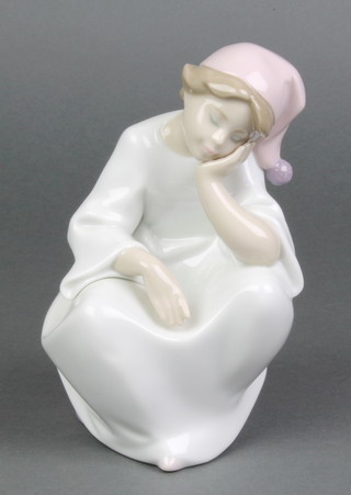 A Lladro figure of a seated dozing child 6 1/2"