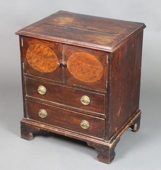 A 19th Century mahogany commode, the upper section fitted a cupboard enclosed by panelled doors, the base fitted 2 long drawers with replacement handles, raised on bracket feet 27"h x 23"w x 18"d 