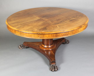 A Victorian circular rosewood dining table, raised on a turned column and triform base with paw feet 28"h x 53"diam. 