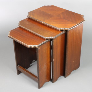 A nest of 3 Art Deco mahogany interfitting coffee tables with quarter veneered tops, raised on panelled supports, largest 21 1/2"h x 20"w x 14", middle 20"h x 17"w x 13"d, smallest 19"h x 14"w x 12"d 