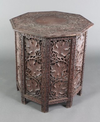 An octagonal Indian pierced and carved hardwood folding occasional table the top heavily carved leaves, 25"h x 26"w x 24 1/2"d  