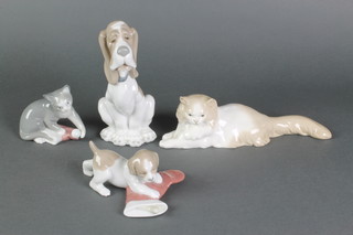 A Nao figure of a seated hound 7", a ditto of a cat 4", another of a puppy 5" and another of a reclining cat 10" 