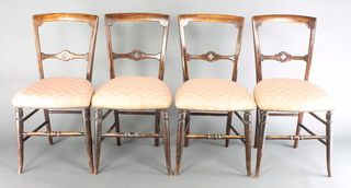 A set of 4 Victorian mahogany bar back bedroom chairs with carved mid rails and upholstered seats, raised on turned supports 