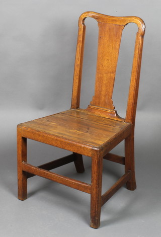 An 18th Century oak slat back hall chair with solid seat, raised on square supports 