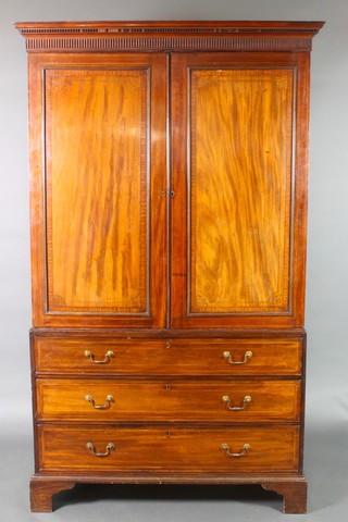 A 19th Century mahogany linen press with moulded and dentil cornice, the upper section fitted a cupboard enclosed by a panelled door, the base fitted 3 long drawers with brass swan neck drop handles, raised on bracket feet 85 1/2"h x 51"w x 25"d 