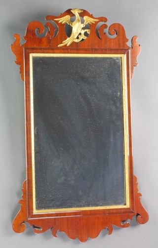 A Chippendale style rectangular plate wall mirror contained in a walnut frame surmounted by a figure of a griffin 25"h x 15"w 