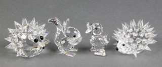 A Swarovski hedgehog 2", a ditto 2", a seated duckling 1 3/4" and a seated squirrel 1 3/4", the first 2 items are boxed 