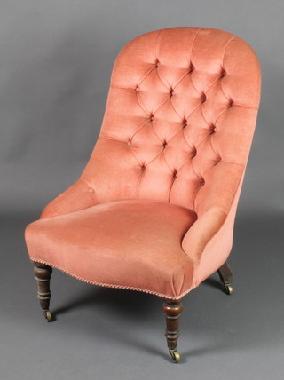 A Victorian tub back nursing chair upholstered in pink buttoned Dralon 