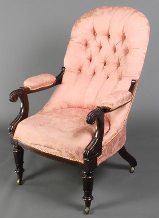 A Victorian mahogany show frame open arm chair upholstered in pink material and raised on turned and fluted supports 