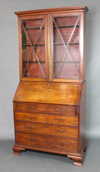 A Georgian mahogany bureau bookcase, the upper section with moulded cornice, the interior fitted shelves enclosed by astragal glazed panelled doors, the base fitted a fall front revealing a fitted interior above 4 long graduated drawers with brass swan neck handles, raised on ogee bracket feet 82 1/2"h x 38"w x 21" d 