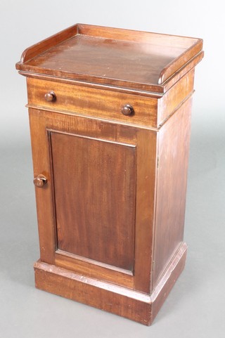 A Victorian mahogany bedside cabinet with 3/4 gallery, fitted a drawer above a panelled door, raised on a platform base 30"h x 16"w x 13"d 