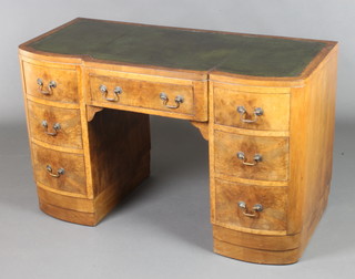 An Art Deco figured walnut kneehole pedestal desk with inset writing surface above 1 long and 6 short drawers with brass swan neck drop handles 28"h x 45"w x 20 1/2"d (This desk does not come apart as it is in one section) 