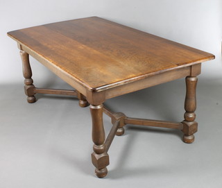 An oak refectory dining table with planked top raised on turned supports with Y shaped stretcher 30"h x 72"l x 40 1/2"w 