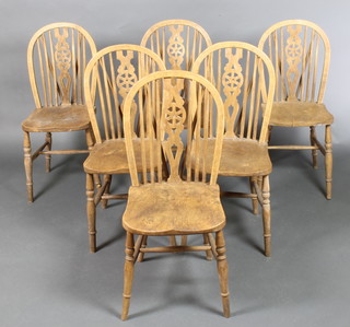 A set of 6  bleached elm wheel back dining chairs, raised on turned supports with H framed stretchers 
