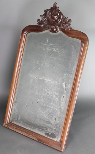 A Continental arch shaped bevelled plate wall mirror contained in a carved oak frame 58"h x 31 1/2"w 