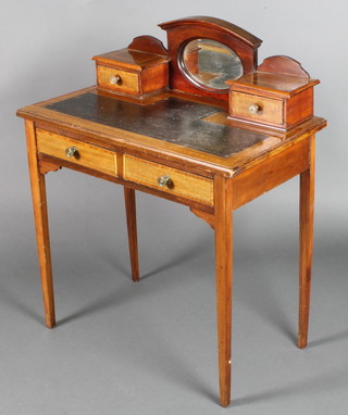 An Edwardian inlaid mahogany writing table the raised mirrored back fitted an oval bevelled plate mirror flanked by 2 short drawers with green inset writing surface above 2 long drawers, raised on square tapered supports 37"h x 30"w x 17"d 

