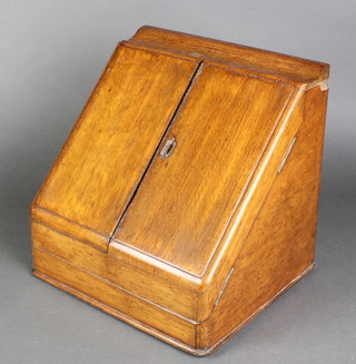 An Edwardian oak stationery box with hinged lid, the stepped interior fitted a secret drawer 11"h x 11"w x 11"d 