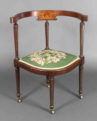 An Edwardian inlaid mahogany tub back corner chair with turned and fluted columns, upholstered seat, raised on turned and fluted supports 