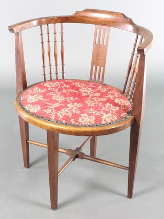 An Edwardian oval inlaid mahogany tub back chair with bobbin turned decoration and pierced slat, having an upholstered seat, raised on square tapering supports with X framed stretcher