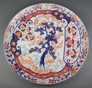 A good late 19th Century Chinese Imari dish decorated with exotic birds beneath trees on a field of flowers 19" 