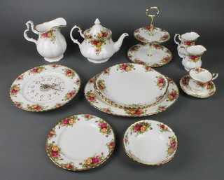A 95 piece Royal Albert Old Country Rose pattern dinner/tea service comprising 12 cups, 12 saucers, 23 small plates, 12 medium plates, 12 dinner plates, 2 cake stands, 2 milk jugs, teapot, 12 dessert bowls, 3 sandwich plates, meat plate, sauce boat and stand, 2 sugar bowls and a timepiece 