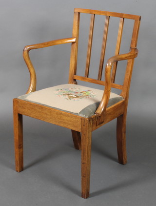 A 19th Century mahogany stick and rail back carver chair with upholstered drop in seat 