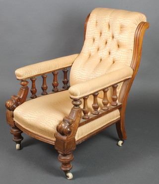 A Victorian mahogany show frame armchair upholstered in gold snakeskin effect material, with bobbin turned decoration 