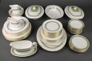 A 62 piece Royal Doulton Rondelay pattern dinner service comprising 12 small saucers, 12 large saucers, 12 small plates, 6 medium plates, 6 large plates, 6 dinner plates, 6 dessert bowls, 2 milk jugs, 2 tureens and covers, 1 open bowl, sandwich plate, meat plate, sauce boat and stand 