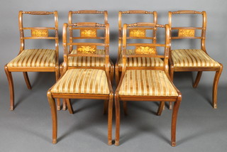 A set of 6 Regency style rope back dining chairs with inlaid mid rails and upholstered drop in seats, raised on sabre supports 