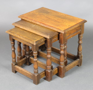 A nest of 3 rectangular Ipswich style oak interfitting coffee tables, raised on turned and block supports 19"h x 20 1/2"w x 13 1/2"d, 18" x 17 1/2" x 12", 16" x 14" x 10" 