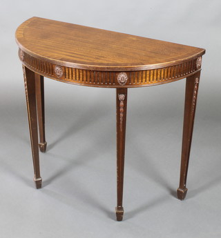 A Georgian style demi-lune hall table with cross-banded top and fluted decoration, raised on square tapering supports, spade feet 30"h x 36"w x 17"d 