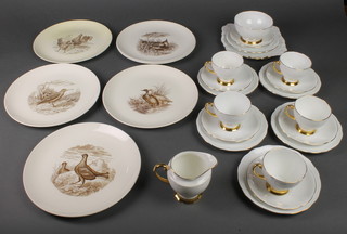 A 21 piece Royal Standard white and gilt banded tea service comprising bread plate, 6 tea plates, sugar bowl, cream jug (damage to handle), 6 cups (1 cracked) and 6 saucers, 6 Copeland Spode plates decorated birds (1 cracked) 