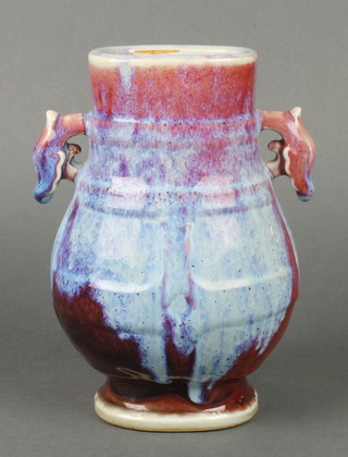An early 20th century sang de boeuf baluster vase with stylised dragon handles 8"
