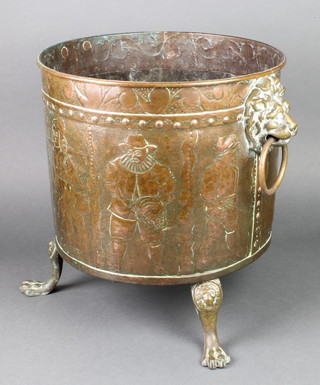 A cylindrical 19th Century Dutch embossed copper coal bin with lion mask handles, raised on 3 paw feet 15"h x 14" diam. 